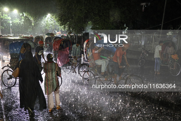 Residents of the city suffer from continuous rain in Dhaka, Bangladesh, on October 4, 2024. 