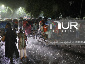 Residents of the city suffer from continuous rain in Dhaka, Bangladesh, on October 4, 2024. (