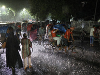 Residents of the city suffer from continuous rain in Dhaka, Bangladesh, on October 4, 2024. (