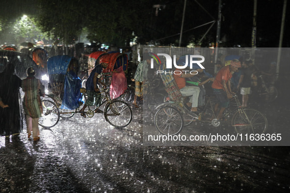 Residents of the city suffer from continuous rain in Dhaka, Bangladesh, on October 4, 2024. 