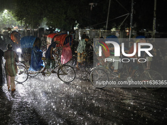 Residents of the city suffer from continuous rain in Dhaka, Bangladesh, on October 4, 2024. (