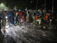 Residents of the city suffer from continuous rain in Dhaka, Bangladesh, on October 4, 2024. (