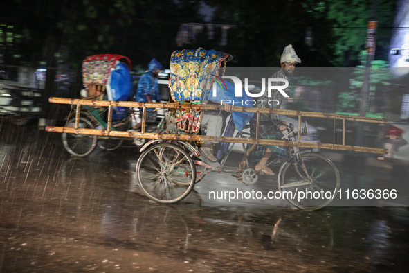 Residents of the city suffer from continuous rain in Dhaka, Bangladesh, on October 4, 2024. 