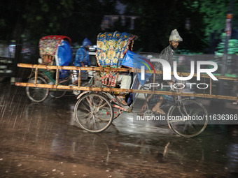 Residents of the city suffer from continuous rain in Dhaka, Bangladesh, on October 4, 2024. (