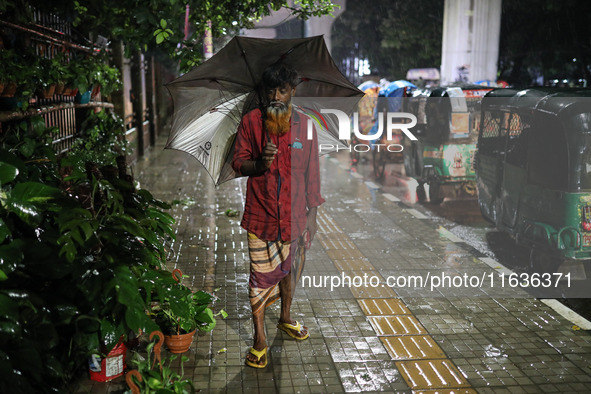 Residents of the city suffer from continuous rain in Dhaka, Bangladesh, on October 4, 2024. 