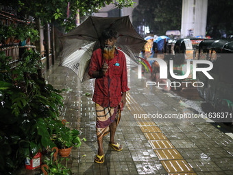 Residents of the city suffer from continuous rain in Dhaka, Bangladesh, on October 4, 2024. (