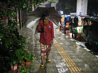 Residents of the city suffer from continuous rain in Dhaka, Bangladesh, on October 4, 2024. (