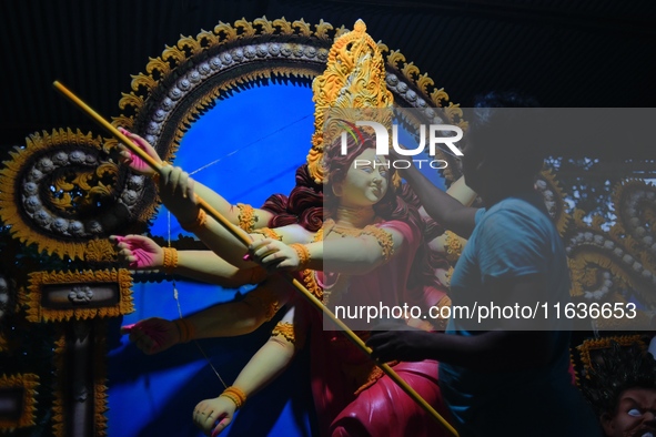 An artist works on an idol of Goddess Durga at a workshop ahead of Durga Puja in Dhaka, Bangladesh, on October 4, 2024. 