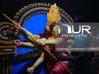 An artist works on an idol of Goddess Durga at a workshop ahead of Durga Puja in Dhaka, Bangladesh, on October 4, 2024. (