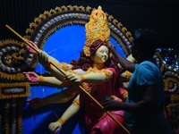 An artist works on an idol of Goddess Durga at a workshop ahead of Durga Puja in Dhaka, Bangladesh, on October 4, 2024. (