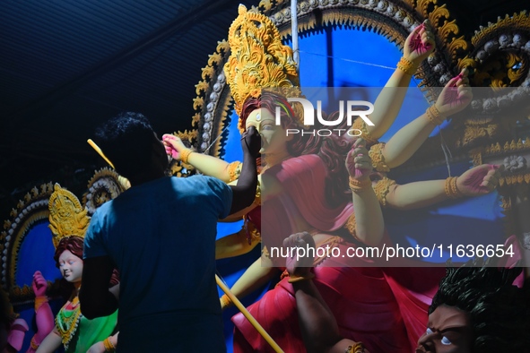 An artist works on an idol of Goddess Durga at a workshop ahead of Durga Puja in Dhaka, Bangladesh, on October 4, 2024. 