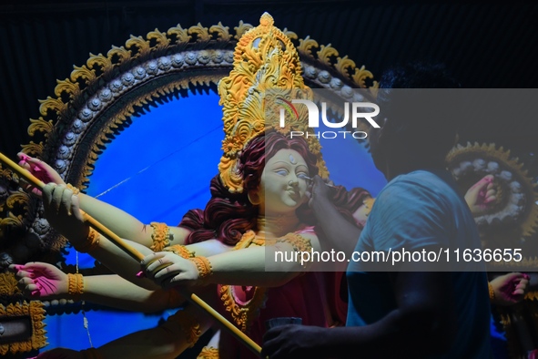 An artist works on an idol of Goddess Durga at a workshop ahead of Durga Puja in Dhaka, Bangladesh, on October 4, 2024. 