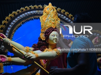 An artist works on an idol of Goddess Durga at a workshop ahead of Durga Puja in Dhaka, Bangladesh, on October 4, 2024. (