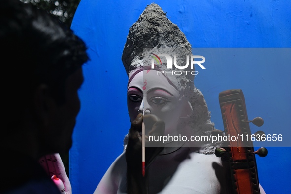 An artist works on an idol of Goddess Durga at a workshop ahead of Durga Puja in Dhaka, Bangladesh, on October 4, 2024. 