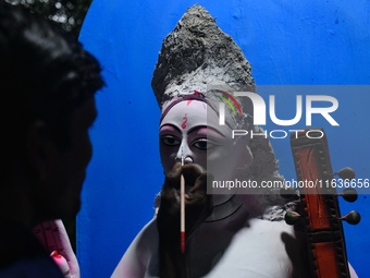 An artist works on an idol of Goddess Durga at a workshop ahead of Durga Puja in Dhaka, Bangladesh, on October 4, 2024. (