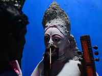 An artist works on an idol of Goddess Durga at a workshop ahead of Durga Puja in Dhaka, Bangladesh, on October 4, 2024. (