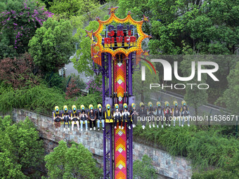 An aerial photo shows the Happy Valley scenic spot in Chongqing, China, on October 3, 2024. Chongqing Happy Valley opens on July 8, 2017, an...