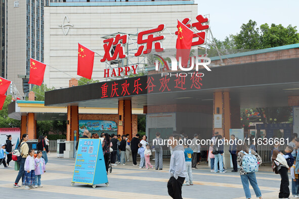 Tourists play at Happy Valley scenic spot in Chongqing, China, on October 4, 2024. Chongqing Happy Valley opens on July 8, 2017, and is the...