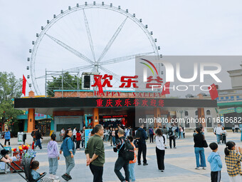 Tourists play at Happy Valley scenic spot in Chongqing, China, on October 4, 2024. Chongqing Happy Valley opens on July 8, 2017, and is the...