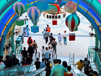 Tourists play at Happy Valley scenic spot in Chongqing, China, on October 4, 2024. Chongqing Happy Valley opens on July 8, 2017, and is the...