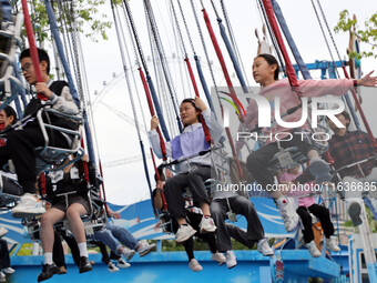 Tourists play at Happy Valley scenic spot in Chongqing, China, on October 4, 2024. Chongqing Happy Valley opens on July 8, 2017, and is the...