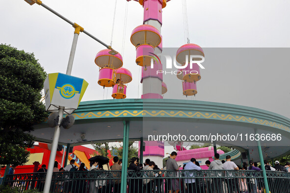 Tourists play at Happy Valley scenic spot in Chongqing, China, on October 4, 2024. Chongqing Happy Valley opens on July 8, 2017, and is the...