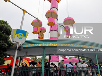 Tourists play at Happy Valley scenic spot in Chongqing, China, on October 4, 2024. Chongqing Happy Valley opens on July 8, 2017, and is the...