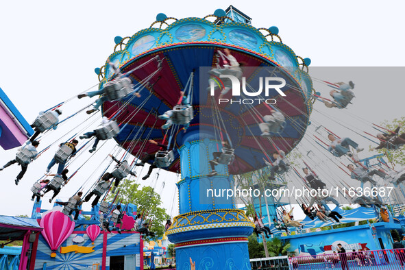 Tourists play at Happy Valley scenic spot in Chongqing, China, on October 4, 2024. Chongqing Happy Valley opens on July 8, 2017, and is the...