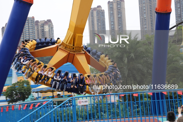 Tourists play at Happy Valley scenic spot in Chongqing, China, on October 4, 2024. Chongqing Happy Valley opens on July 8, 2017, and is the...