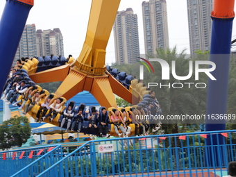 Tourists play at Happy Valley scenic spot in Chongqing, China, on October 4, 2024. Chongqing Happy Valley opens on July 8, 2017, and is the...