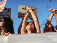 Demonstrators with clenched fists above their heads shout slogans against President Kais Saied during a demonstration organized by the Tunis...