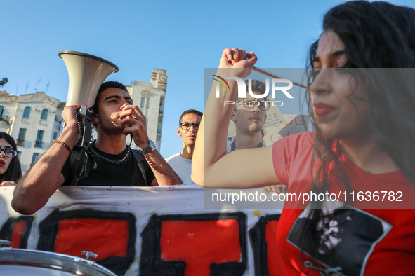 A young demonstrator shouts slogans against President Kais Saied on a megaphone during a demonstration organized by the Tunisian Network for...