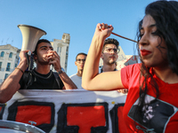 A young demonstrator shouts slogans against President Kais Saied on a megaphone during a demonstration organized by the Tunisian Network for...