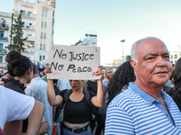 A young woman raises a placard that reads in Arabic, ''no justice no peace,'' during a demonstration organized by the Tunisian Network for R...