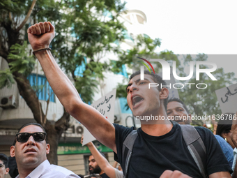 A young man shouts slogans against President Kais Saied and raises his fist during a demonstration organized by the Tunisian Network for Rig...