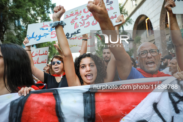 Demonstrators shout slogans against President Kais Saied as they raise their fists during a demonstration organized by the Tunisian Network...