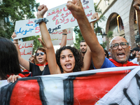 Demonstrators shout slogans against President Kais Saied as they raise their fists during a demonstration organized by the Tunisian Network...