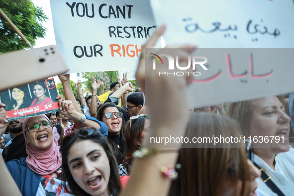 Demonstrators shout slogans against President Kais Saied and raise a placard that reads, ''You cannot resist our rights,'' during a demonstr...