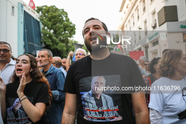 Elyes Chaouachi, son of political prisoner Ghazi Chaouachi, wears a T-shirt bearing a photo of his father and attends a demonstration organi...