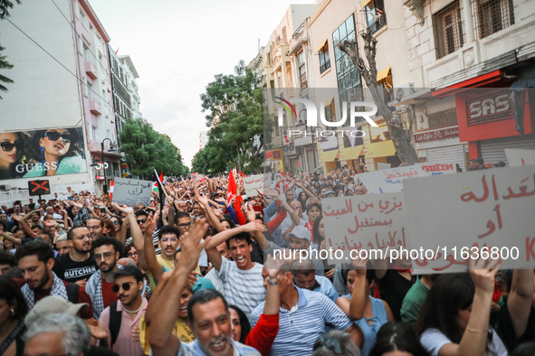 Hundreds of Tunisians raise their arms as they shout ''Degage'' (English: get out) during a demonstration organized by the Tunisian Network...