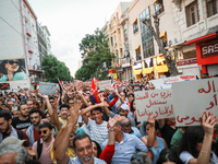 Hundreds of Tunisians raise their arms as they shout ''Degage'' (English: get out) during a demonstration organized by the Tunisian Network...