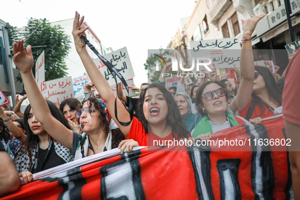 Tunisians raise their arms as they shout ''Degage'' (English: get out) during a demonstration organized by the Tunisian Network for Rights a...