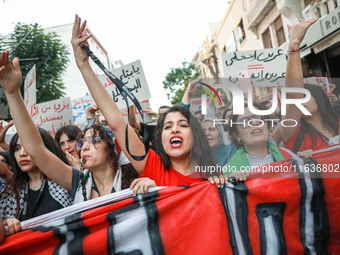 Tunisians raise their arms as they shout ''Degage'' (English: get out) during a demonstration organized by the Tunisian Network for Rights a...