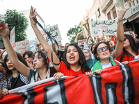 Tunisians raise their arms as they shout ''Degage'' (English: get out) during a demonstration organized by the Tunisian Network for Rights a...