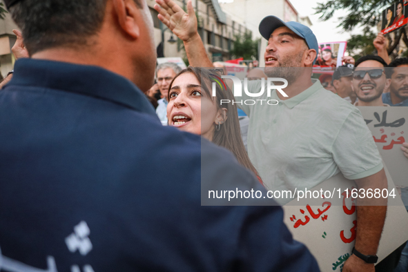 A young Tunisian woman faces a security forces member during a demonstration organized by the Tunisian Network for Rights and Freedoms in Tu...