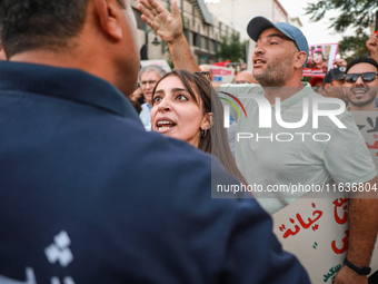 A young Tunisian woman faces a security forces member during a demonstration organized by the Tunisian Network for Rights and Freedoms in Tu...