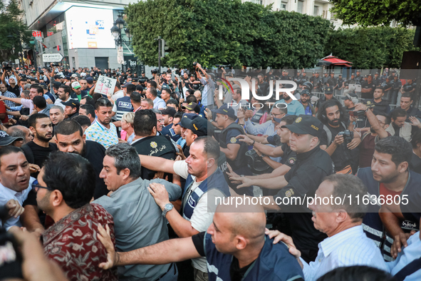 Scuffles erupt between demonstrators and riot police during a demonstration organized by the Tunisian Network for Rights and Freedoms in Tun...