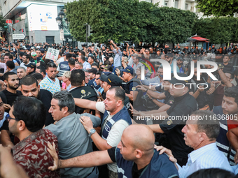 Scuffles erupt between demonstrators and riot police during a demonstration organized by the Tunisian Network for Rights and Freedoms in Tun...