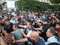 Scuffles erupt between demonstrators and riot police during a demonstration organized by the Tunisian Network for Rights and Freedoms in Tun...