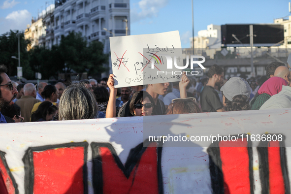 A young Tunisian woman raises a placard that reads in Arabic, ''Down with Decree 54,'' during a demonstration organized by the Tunisian Netw...